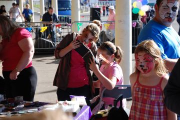 Members of the public with dog face painting on Blackpool's Promanade. Part of the Blackpool Pet Tastic event.