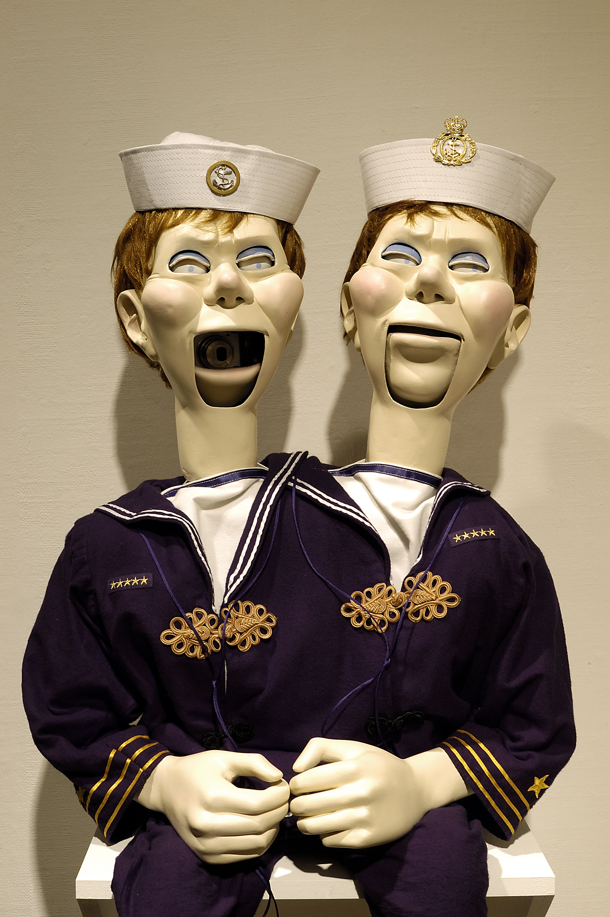 2 headed ventriloquist dummy. The dummy is dressed as a sailor, one head has mouth open, the other mouth closed. Included in the exhibition Lindsay Seers: I Can’t Tell You.