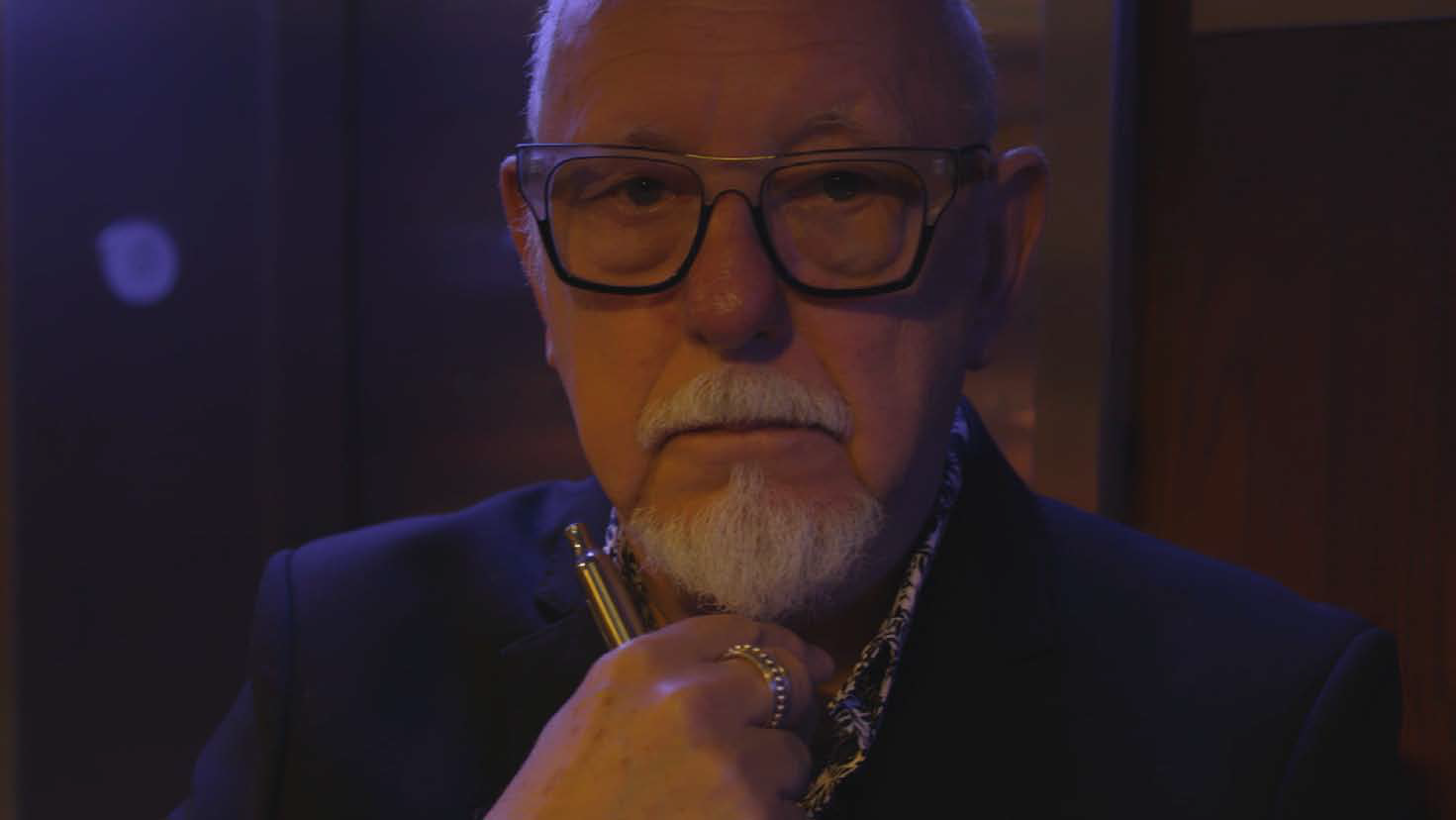 Image of film showing close up of older man in glasses. Part of a series of films and images exploring the lifestyles of older male members of the LGBTQ community.