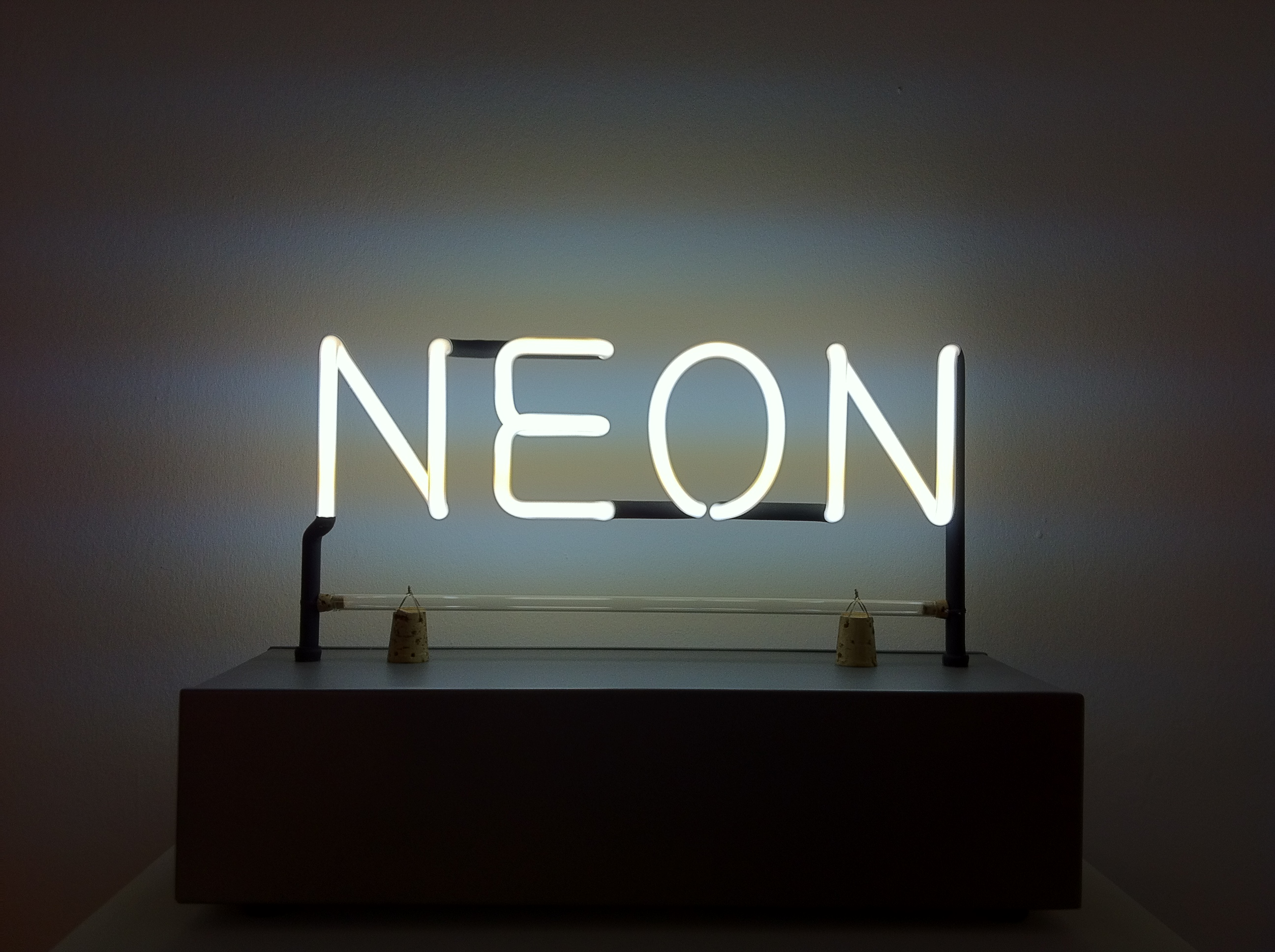 Neon artwork by artist Joseph Kosuth. The artwork is of the word neon in white neon lettering. Included in the exhibition NEON, The Charged Line.