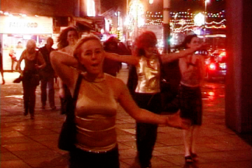 Image from the film Pleasure Beach by artist Nina Könneman that records the nightlife of Blackpool. The image is of a group of women walking down Blackpool’s promenade